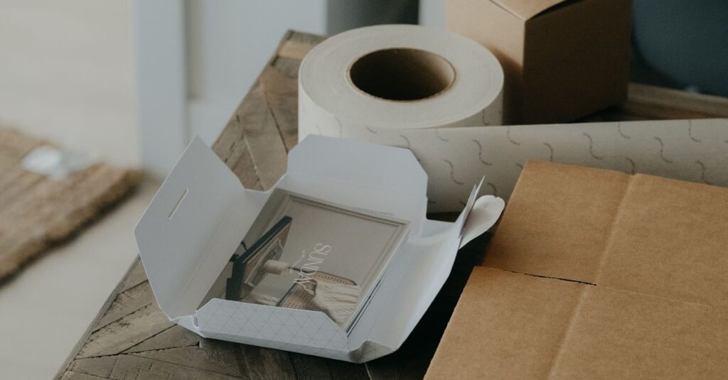 A collection of eco-friendly packaging materials laid out on a rustic wooden table.