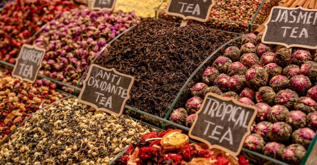A vibrant display of various teas at a market stall, highlighting diverse flavors and colors.