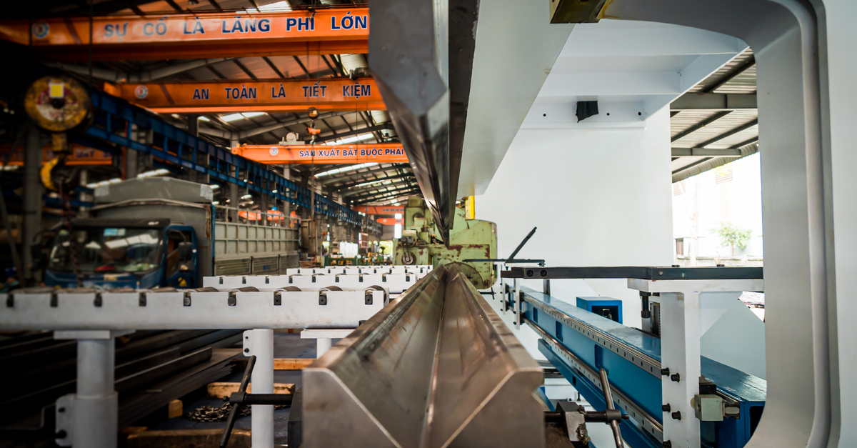 Interior view of an industrial building featuring machinery and metal conveyor systems.