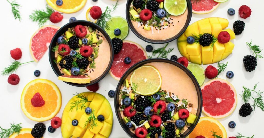 A colorful assortment of fresh fruit bowls featuring mixed berries and citrus slices, perfect for healthy eating inspiration.