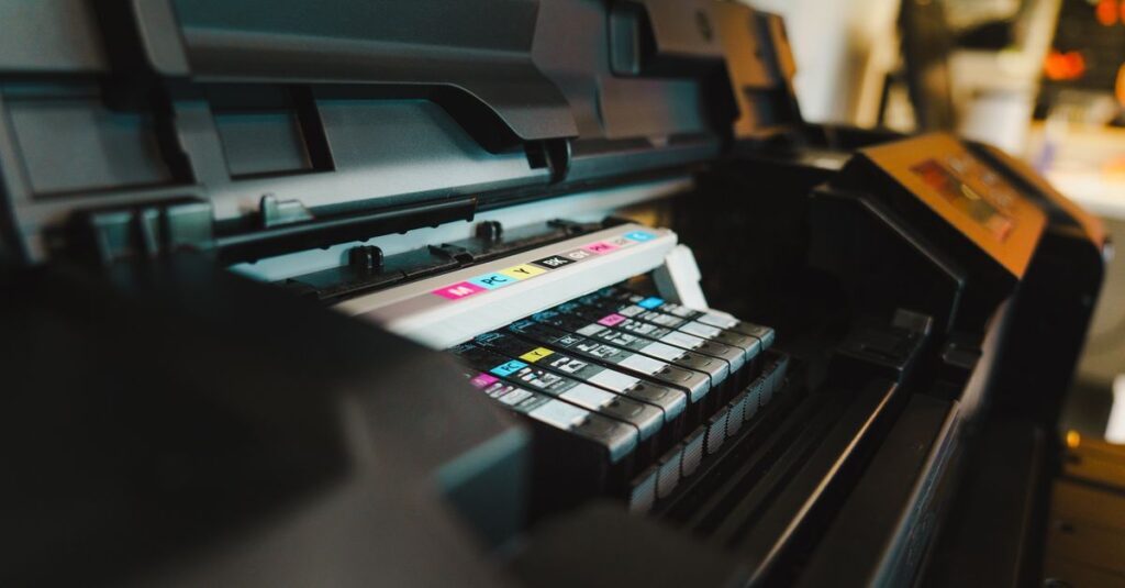 Detailed view of ink cartridges inside a digital inkjet printer in an office setting.