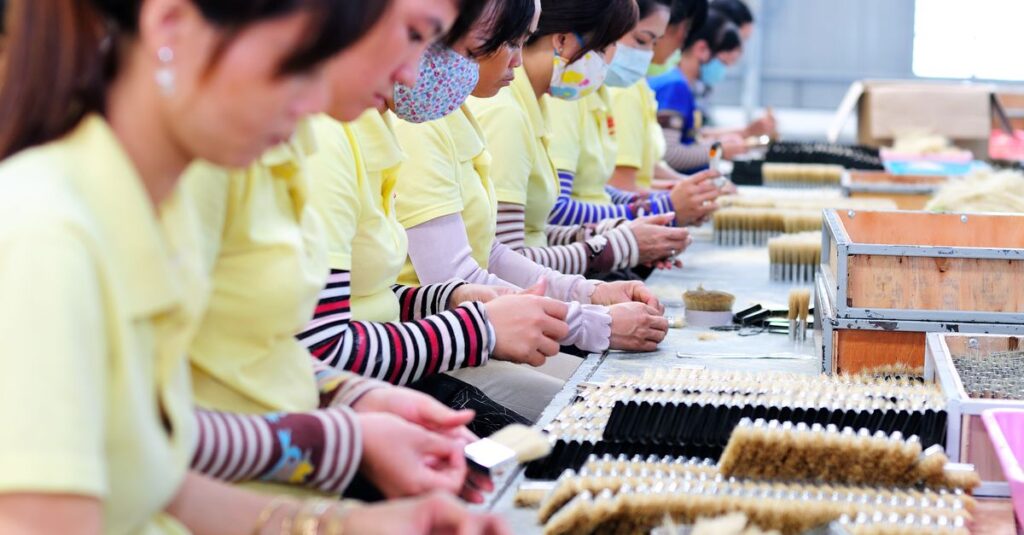 Women in a factory focusing on manufacturing with teamwork and precision.
