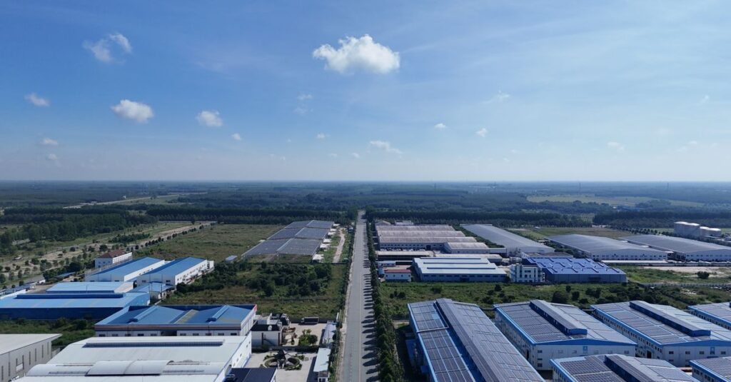 Aerial view showcasing the vast industrial park landscape under a clear blue sky in Bình Dương, Vietnam.