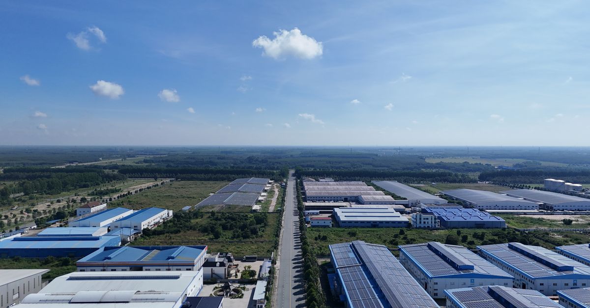 Aerial view showcasing the vast industrial park landscape under a clear blue sky in Bình Dương, Vietnam.