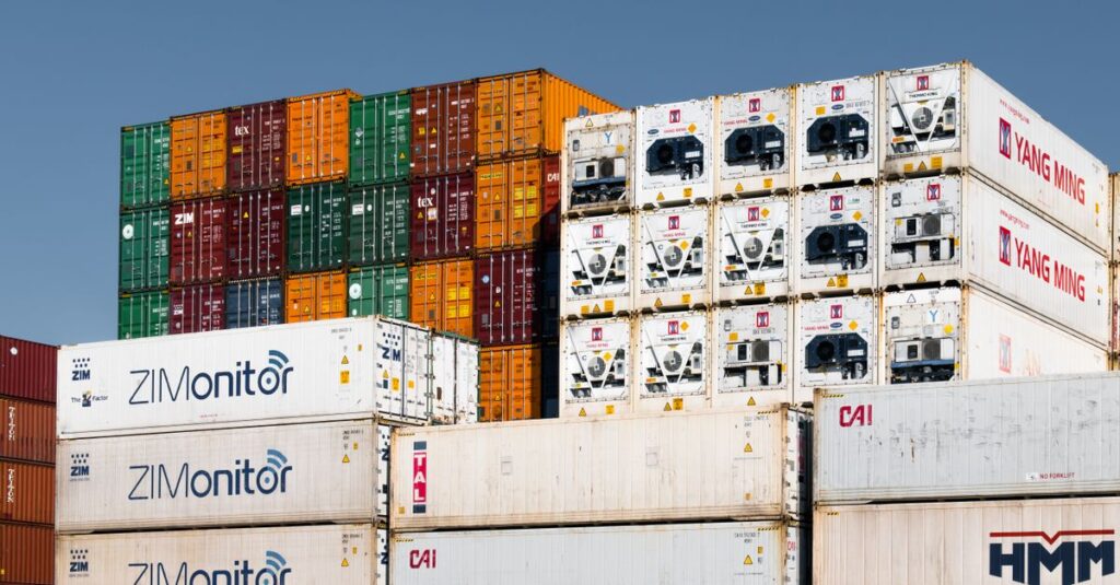 Colorful stacked shipping containers at Hamburg port, Germany, showcasing global trade logistics.