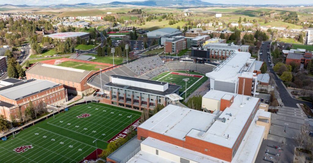 Drone shot of Washington State University campus featuring sports fields and buildings in Pullman, WA.