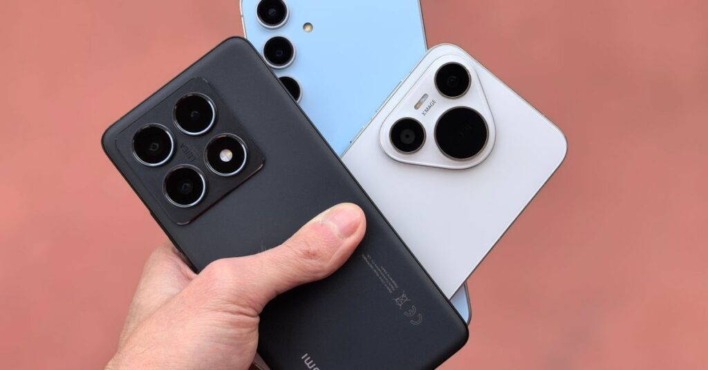 Close-up of a hand holding three modern smartphones with cameras in view, showcasing contemporary design.