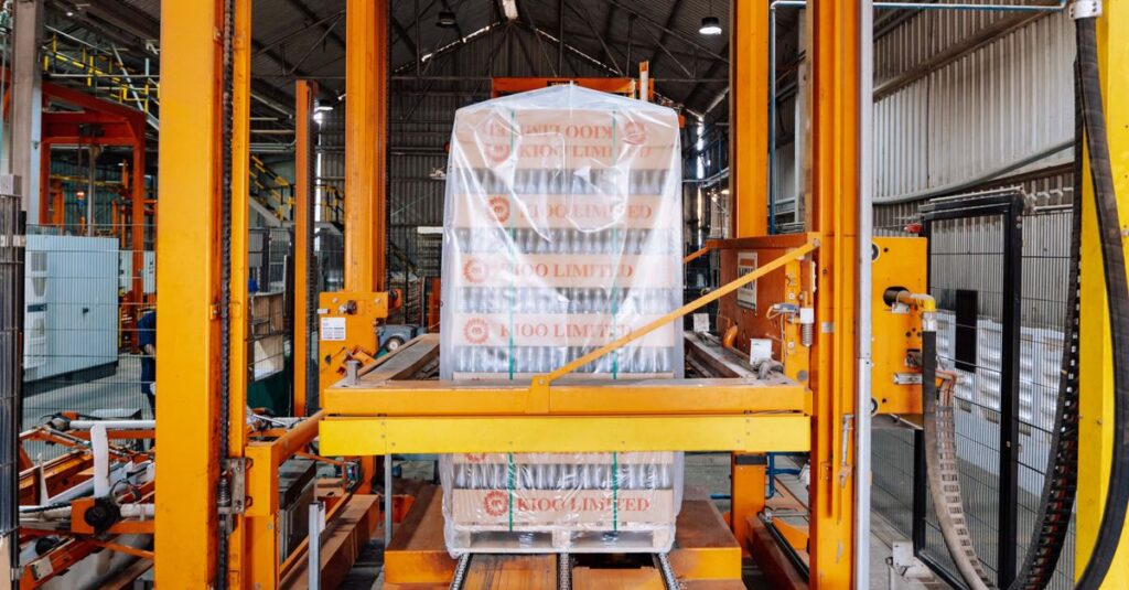 An industrial machine in a glass factory showcasing automated packaging in Dar es Salaam.