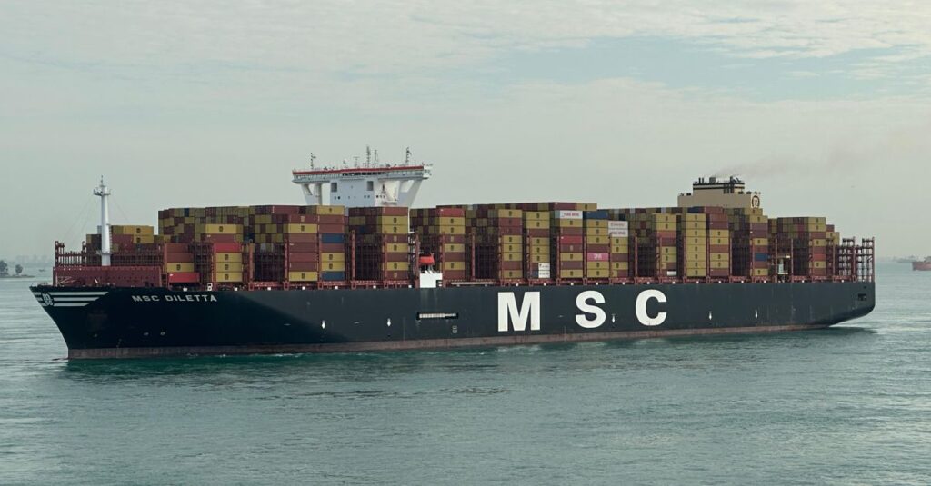 MSC cargo ship with stacked containers navigating open waters under cloudy sky.
