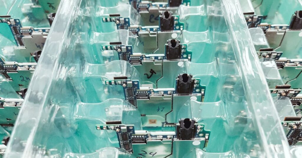 Detailed view of organized electronic circuit boards in a production setting.