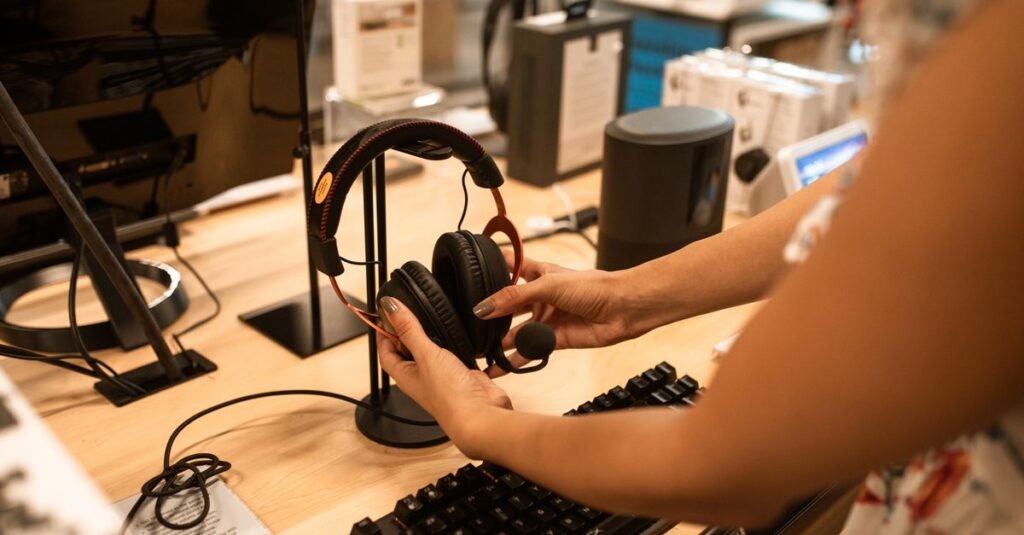 A woman examines headphones in an electronics store, focusing on the audio device's features.