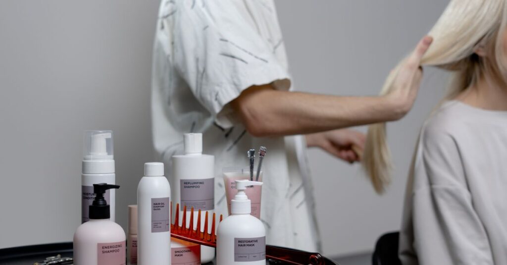 A hairdresser styling a blonde woman's hair in a salon, showcasing hair care products on a table.