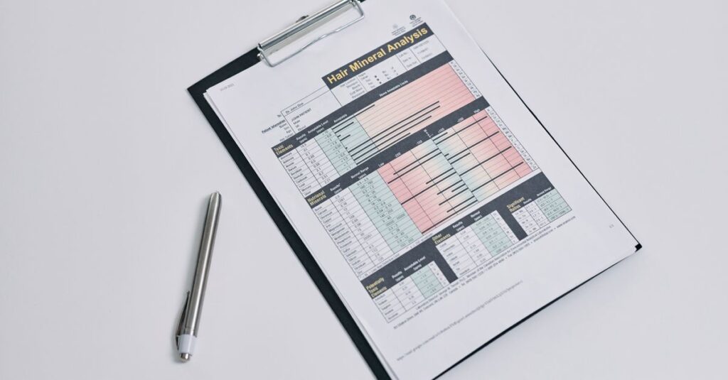 A hair mineral analysis form on a clipboard with a silver pen on a white background.