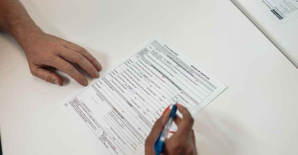 Two people reviewing and signing adoption documents, symbolizing legal procedures and family planning.