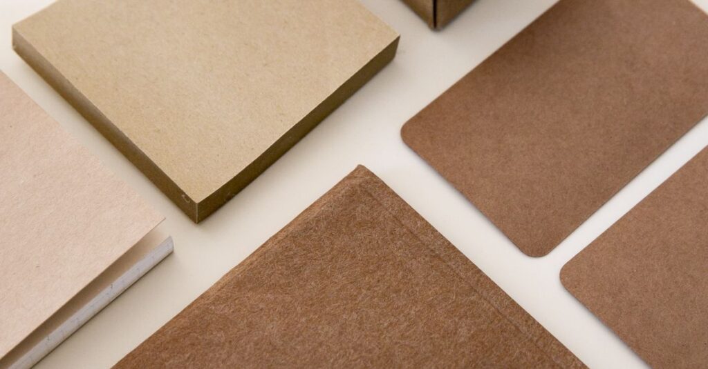 Geometric arrangement of kraft paper stationery products showcased in a minimalist style.