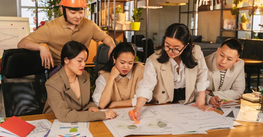 A diverse team of professionals working together on architectural plans in a modern office setting.