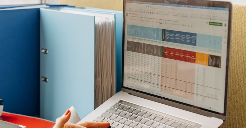 Business workspace with folders and laptop showing analytics screen. Ideal for tech and work themes.