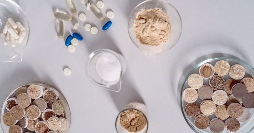 High-angle shot of various pharmaceutical ingredients and pills on a white surface. Ideal for healthcare and science themes.