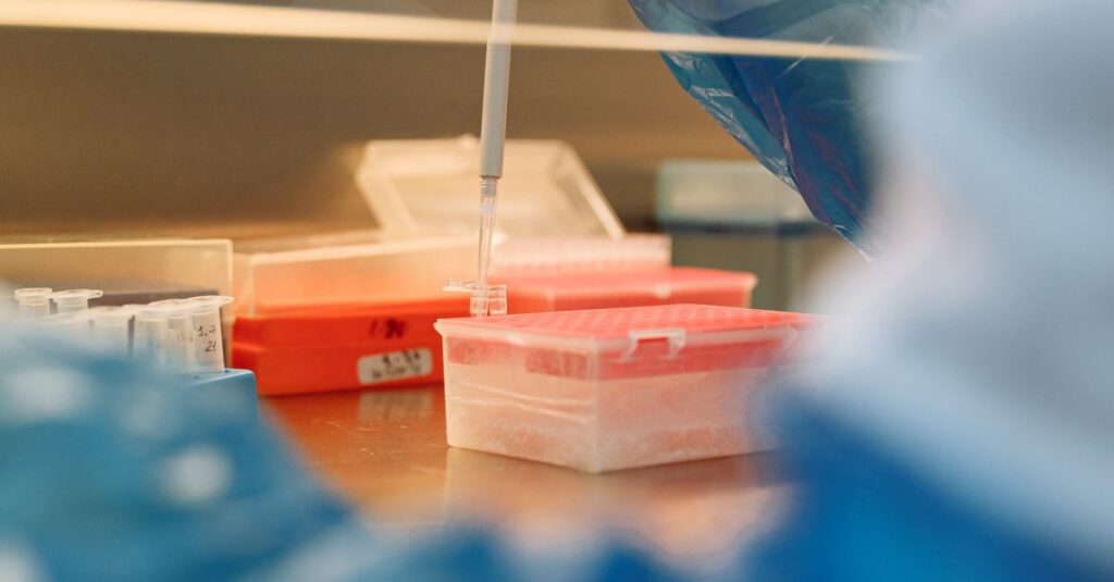 Close-up of a scientist using a pipette in a modern laboratory setting.