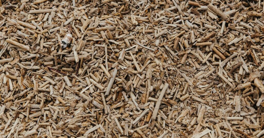 Close-up view of a textured surface of natural brown wood chips, ideal for organic and environmental themes.