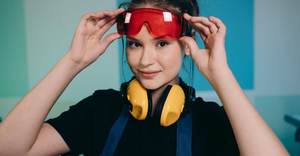Smiling woman adjusting safety goggles with headphones, indoors setting.